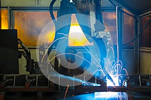 Robots welding in a car factory