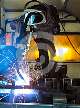 Robots welding in a car factory