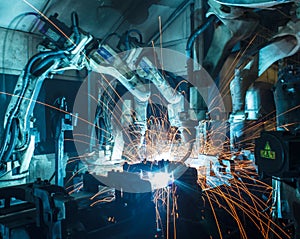 Robots welding in a car factory