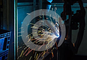 Robots welding in a car factory