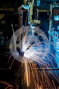 Robots welding in a car factory