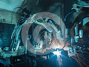 Robots welding in a car factory