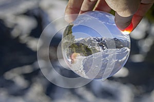 Roc Del Quer trekking trail, reflection view through crystal ball. Andorra. photo