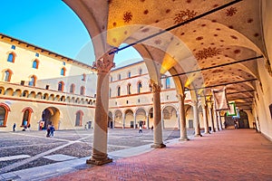 The Rocchetta courtyard with scenic arcades and pebbled ground, Sforza`s Castle in Milan, Italy