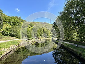 The Rochdale canal, with footpaths, and a narrow boat near, Todmorden, Yorkshire, UK