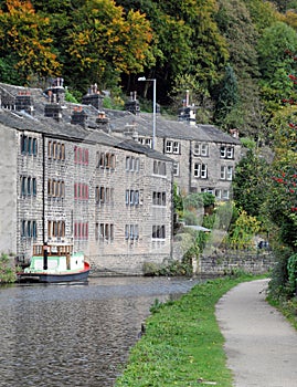 the rochdale canal at hebden bridge with towpath boat and stone