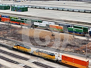 Union Pacific Railroad locomotives pulling a freight train with Global III freight yard in the background