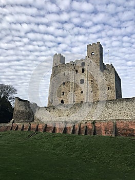 Rochester Castle surrounded by cumulus clouds in Kent, United Kingdom