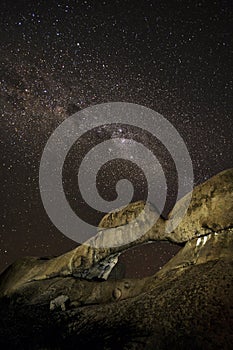 Rock arch under stars