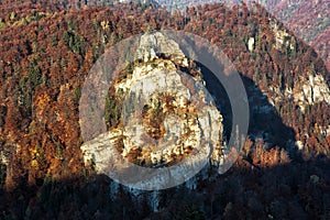 The rock in autumn forest by sunset in Harmanec, Slovakia, beaut