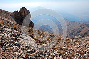 Rock on the background of the panorama of mountains of Tien Shan