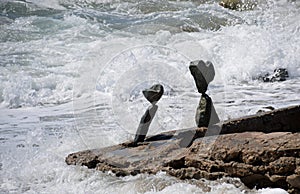 Rock balancing art on beach rocks in Laguna Beach, California.