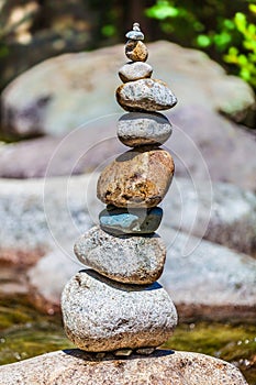 Rock balancing or stone balancing. Rocks stacking. River.