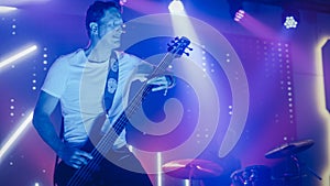 Rock Band Performing at a Concert in a Night Club. Portrait of a Lead Guitarist Playing on a Guita