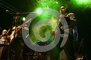 Rock band setting nightlife in Mexico city latin america string trio with two electric guitars  vocalist and drummer among