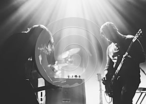 Rock band on a stage in a backlights