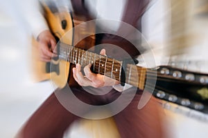 Rock band studio rehearsal. Male musician playing bass guitar before live concert with motion blur effect