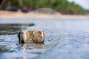 Rock barnacle attach on  beer can garbage leaving in sea for a long time at beach front