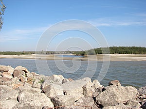 Rock barrier and sand islands with willow trees Danube river