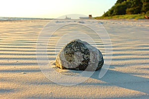 Rock on the beach during sunset