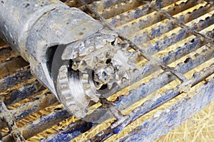 A rock bit on back of drill rig.