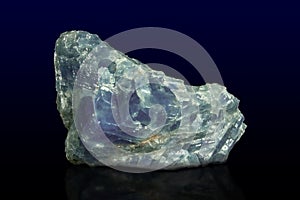 Rock of blue calcite mineral on dark background photo