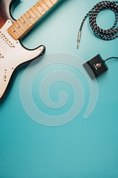 Rock, blues guitar and equipment on a teal background.