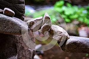 Rock bridge, pyramid, rock balancing art. Close-up of a stack of stones in perfect balance in a mountain forest.