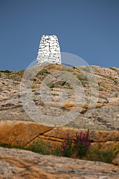 Rock cairn marking the waterway at the rocky coast near Smogen in Sweden