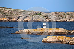 Rock cairn marking the waterway at the rocky coast of Smogen in Sweden