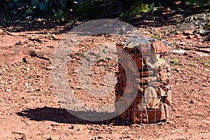 Rock cairn, trail marker secured by chain link fence fabric