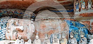 Rock carving of Sakyamuni Buddha entering Nirvana, with his disciples photo