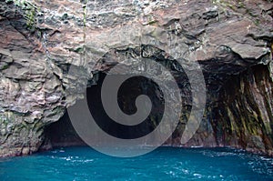 Rock cave on Vestmanna sea cliffs on Faroe Islands photo