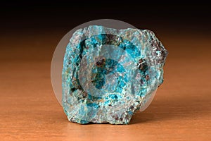 Rock of Chrysocolla mineral from Peru over a wooden table photo