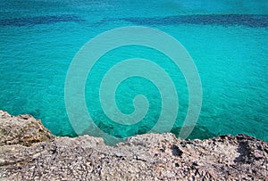 Rock and clear turquoise water background