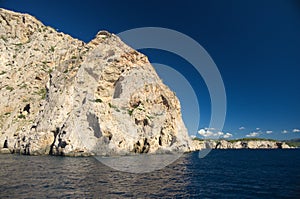 Rock and cliff in blue sea photo