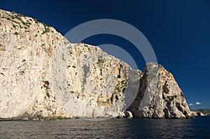 Rock and cliff in blue sea photo