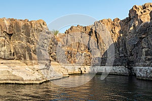 Rock cliffs along the banks of the Nile river in Aswan