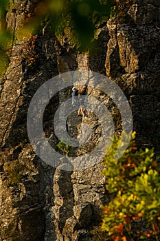 Rock climber. Active lifestyle, risky hobbies, dangerous adrenaline sports background. Male climber climbing Hradok.