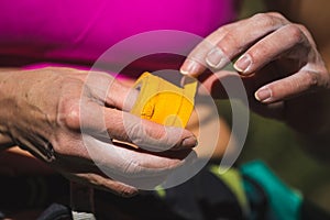 Rock climber bandages his fingers with a protection tape