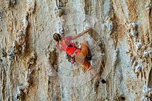 Rock climber on tufas climbing route in Kalymnos, Greece photo