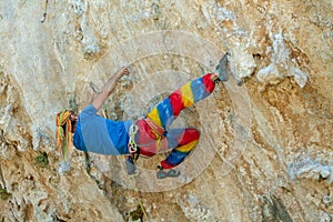 Rock climber on tufas climbing route in Kalymnos, Greece photo