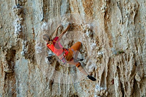 Rock climber on tufas climbing route in Kalymnos, Greece photo