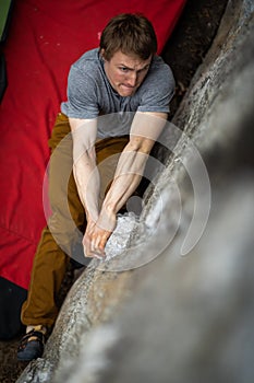 A rock climber climbing on a boulder rock outdoors