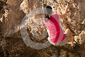 Rock climber climbing on seaside cliff