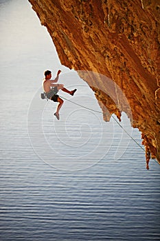 Rock climber falling of cliff while lead climbing