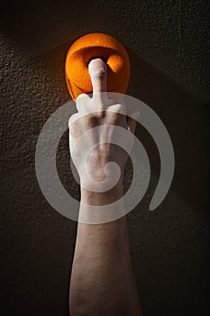 Rock climber gripping handhold with one finger