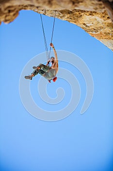 Rock climber hanging on rope