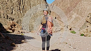 Rock climber in a helmet walks along a canyon