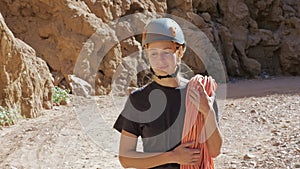 Rock climber in a helmet walks along a canyon